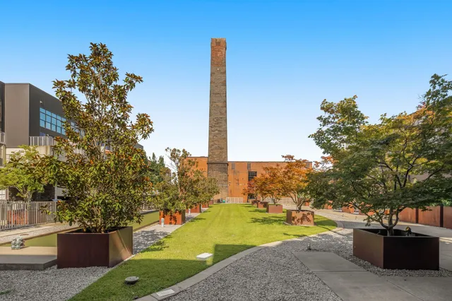 a view of a patio with couches and a table and chairs with wooden fence