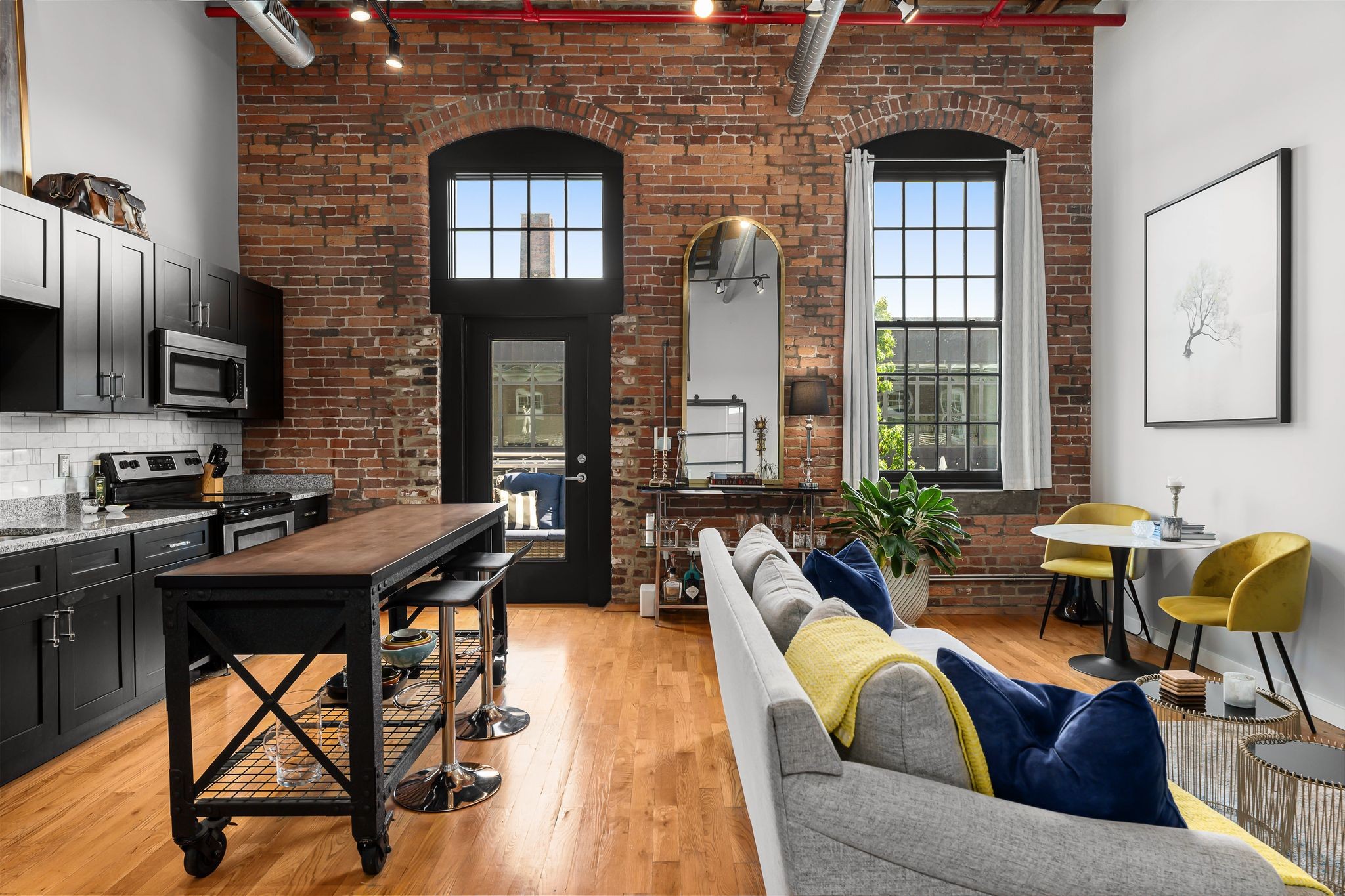 1350 Rosa L Parks Boulevard, Unit 463 Nashville, TN 37208 - Photo 3 of 44 a living room with furniture a chandelier and a piano