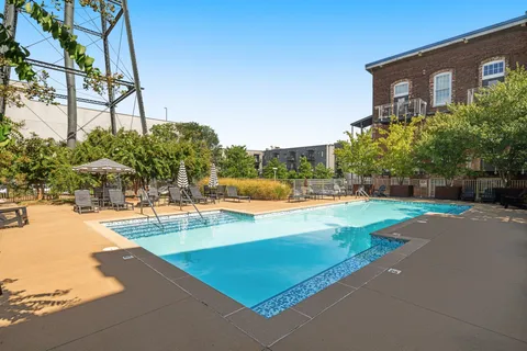 a view of a swimming pool with an outdoor space and seating area