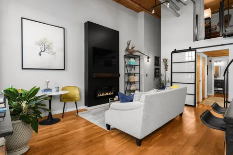 a living room with furniture rug and wooden floor