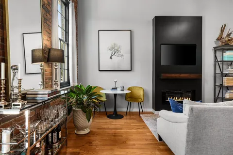a living room with fireplace furniture and a flat screen tv