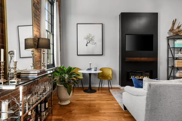 a living room with fireplace furniture and a flat screen tv