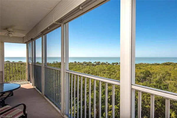 a view of a balcony with lake view and wooden floor