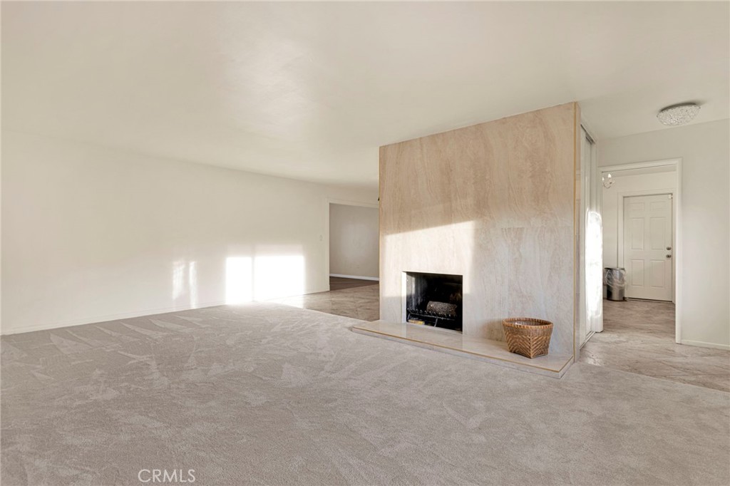 15177 Mendota Road North Apple Valley, CA 92307 - Photo 3 of 50 a view of a livingroom with a fireplace and window