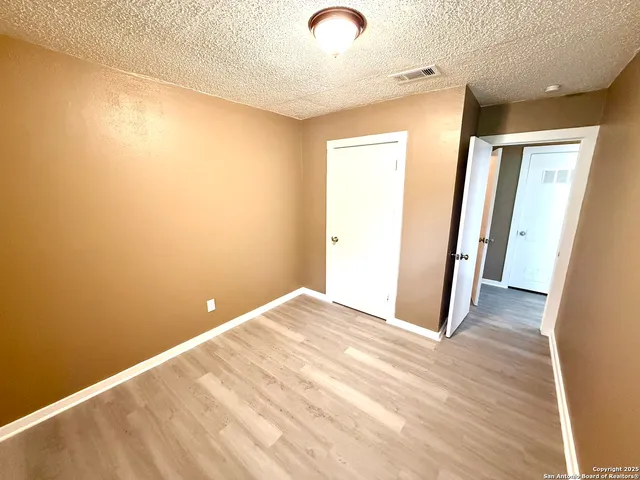 a view of a room with wooden floor