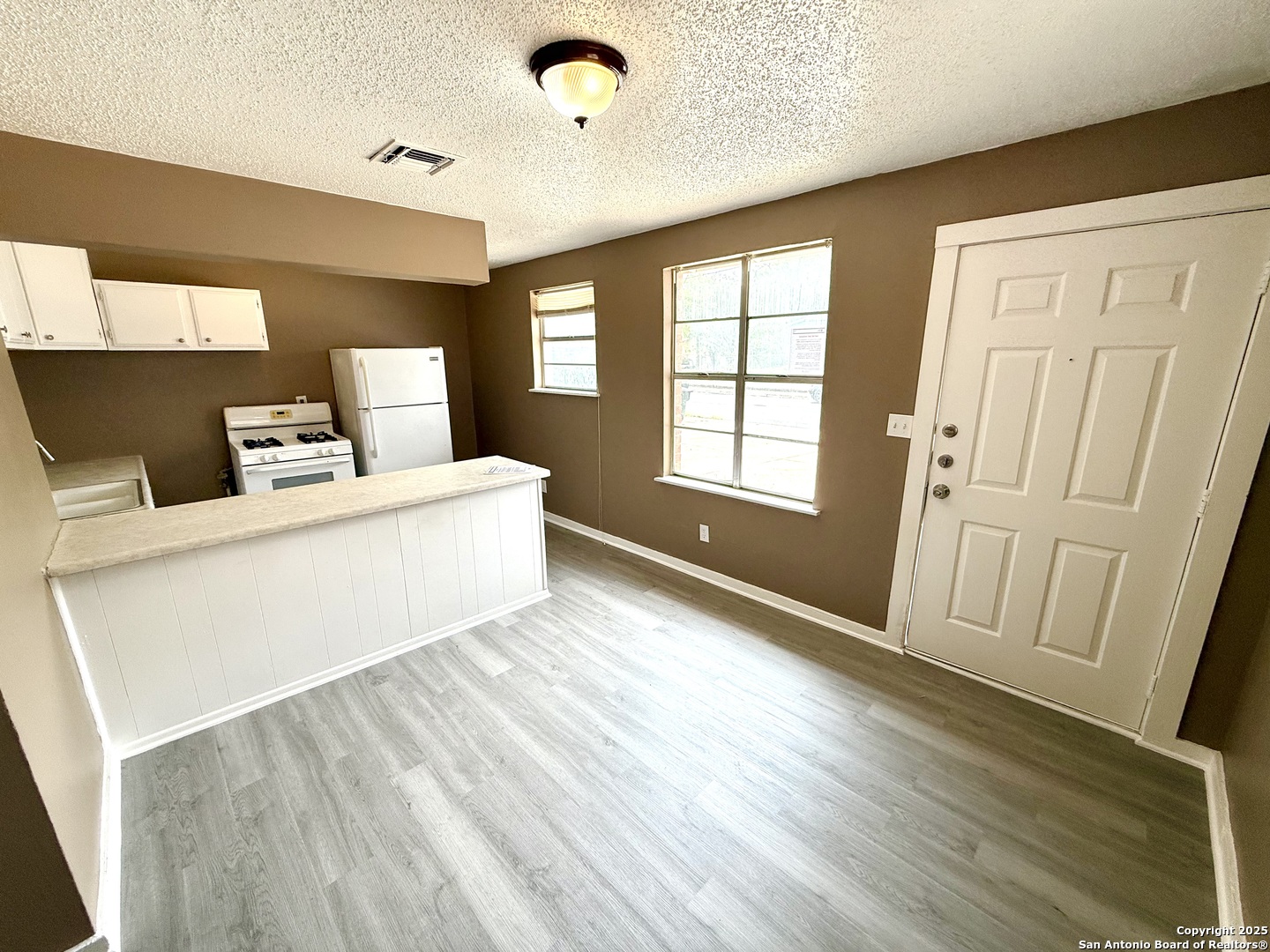 1827 East Highland Boulevard San Antonio, TX 78210 - Photo 4 of 17 a bedroom with a bed and wooden floor