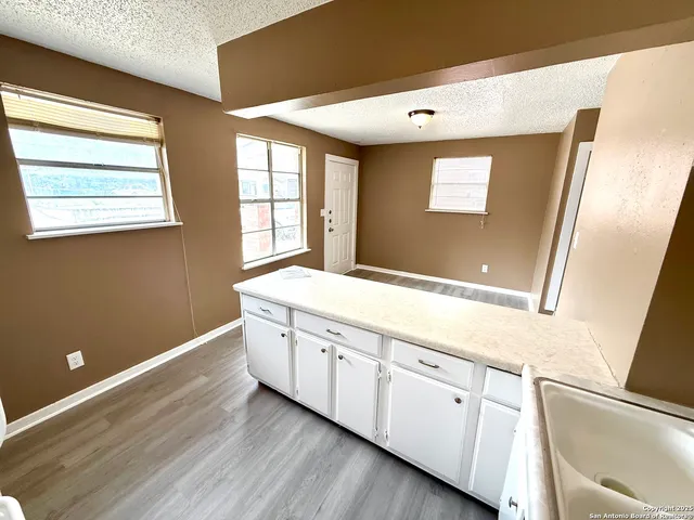 a view of cabinets with wooden floor and window