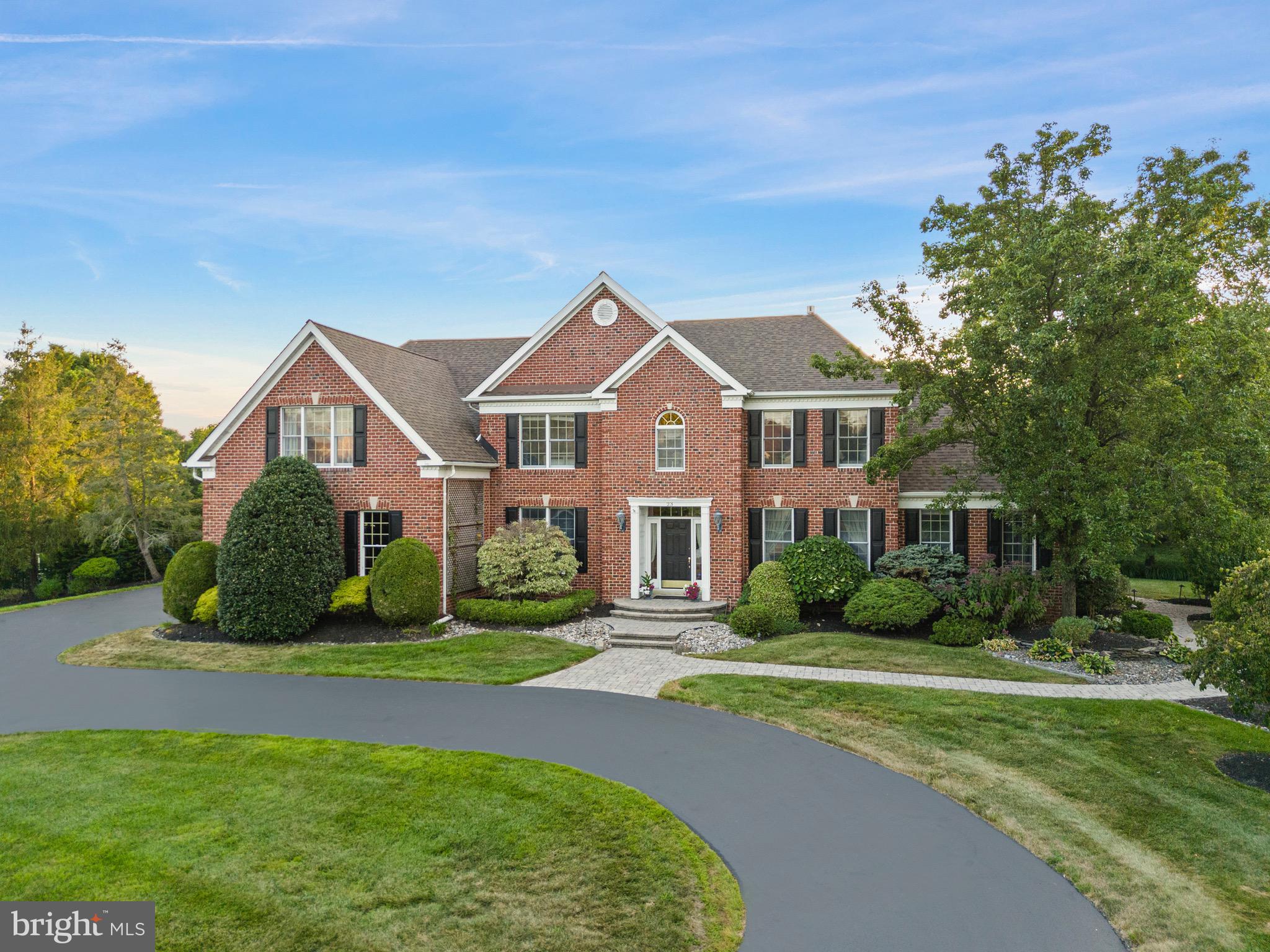 23 Apple Orchard Road Moorestown, NJ 08057 - Photo 2 of 72 a front view of a house with a yard and garage