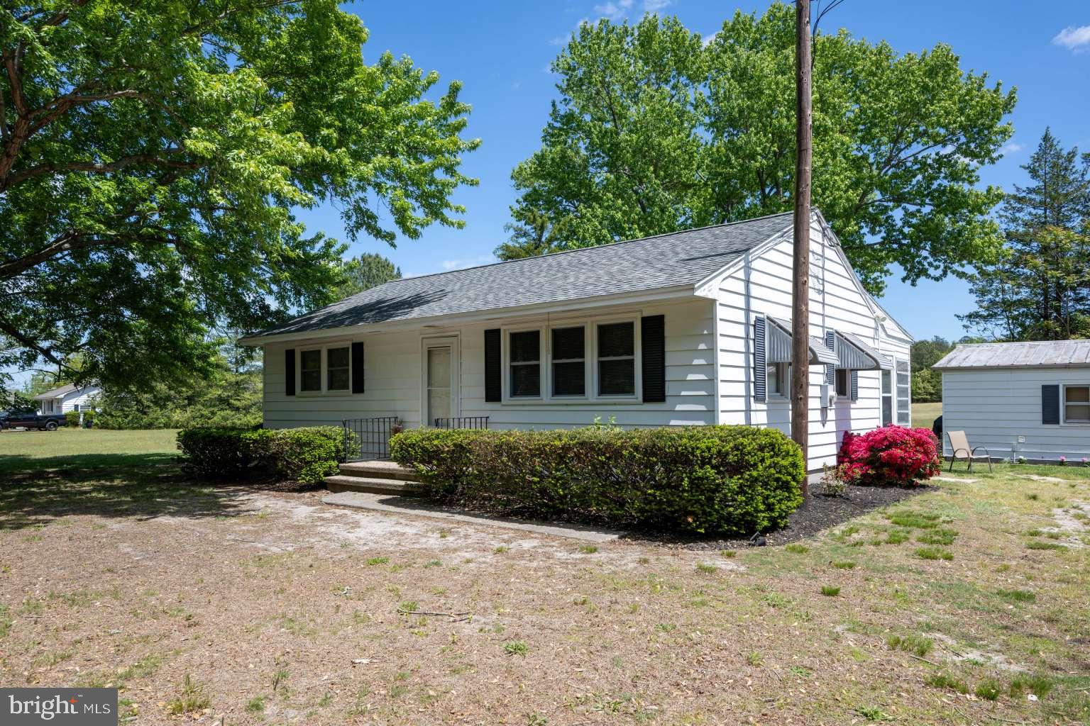 37186 Clubhouse Road Ocean View, DE 19970 - Photo 10 of 14 a front view of a house with a yard