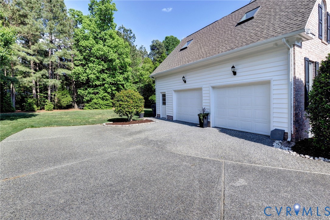 4015 Cold Spring Road Williamsburg, VA 23188 - Photo 42 of 57 Two-car garage with white paneled doors and wall-m