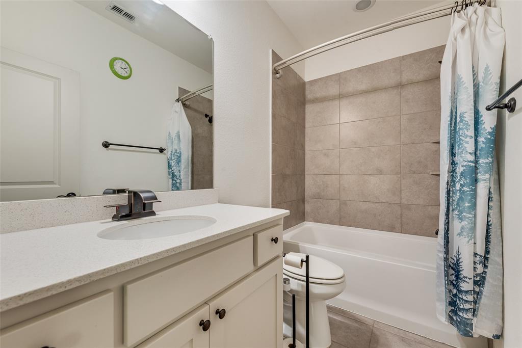 2021 Calisto Way Allen, TX 75013 - Photo 30 of 34 Bathroom vanity featuring a light-colored countertop, undermount sink, and dark-finish faucet