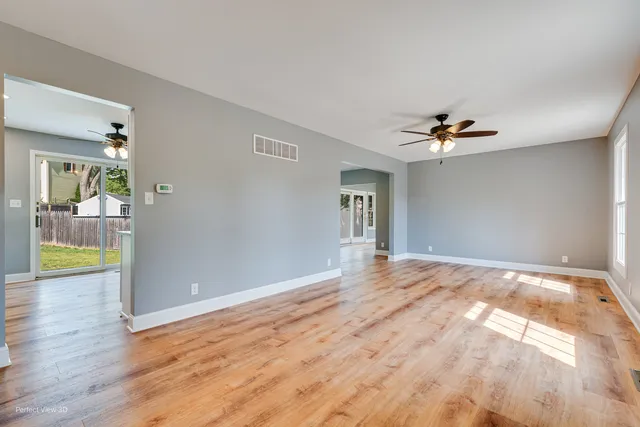 a kitchen with granite countertop a sink cabinets stainless steel appliances and a window