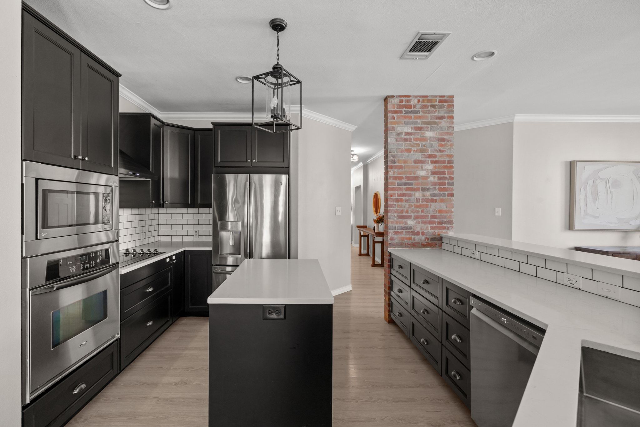 208 Sailors Run Lakeway, TX 78734 - Photo 10 of 40 Preparing festive meals will be a breeze with the high-quality stainless-steel appliances which include an electric cooktop with a vented range hood.