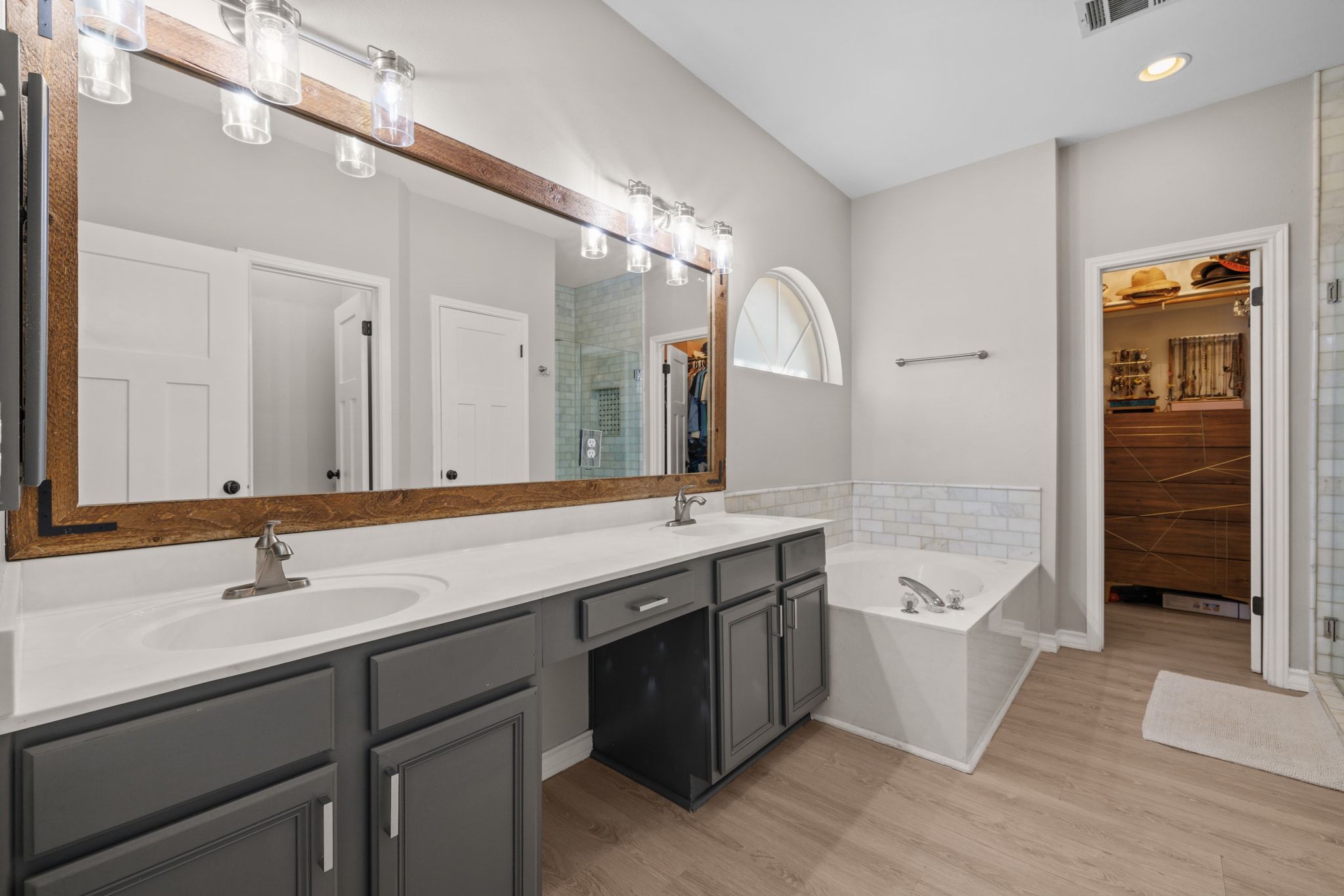 208 Sailors Run Lakeway, TX 78734 - Photo 14 of 40 The primary bathroom has a relaxed atmosphere with a double vanity and a dedicated make-up area.