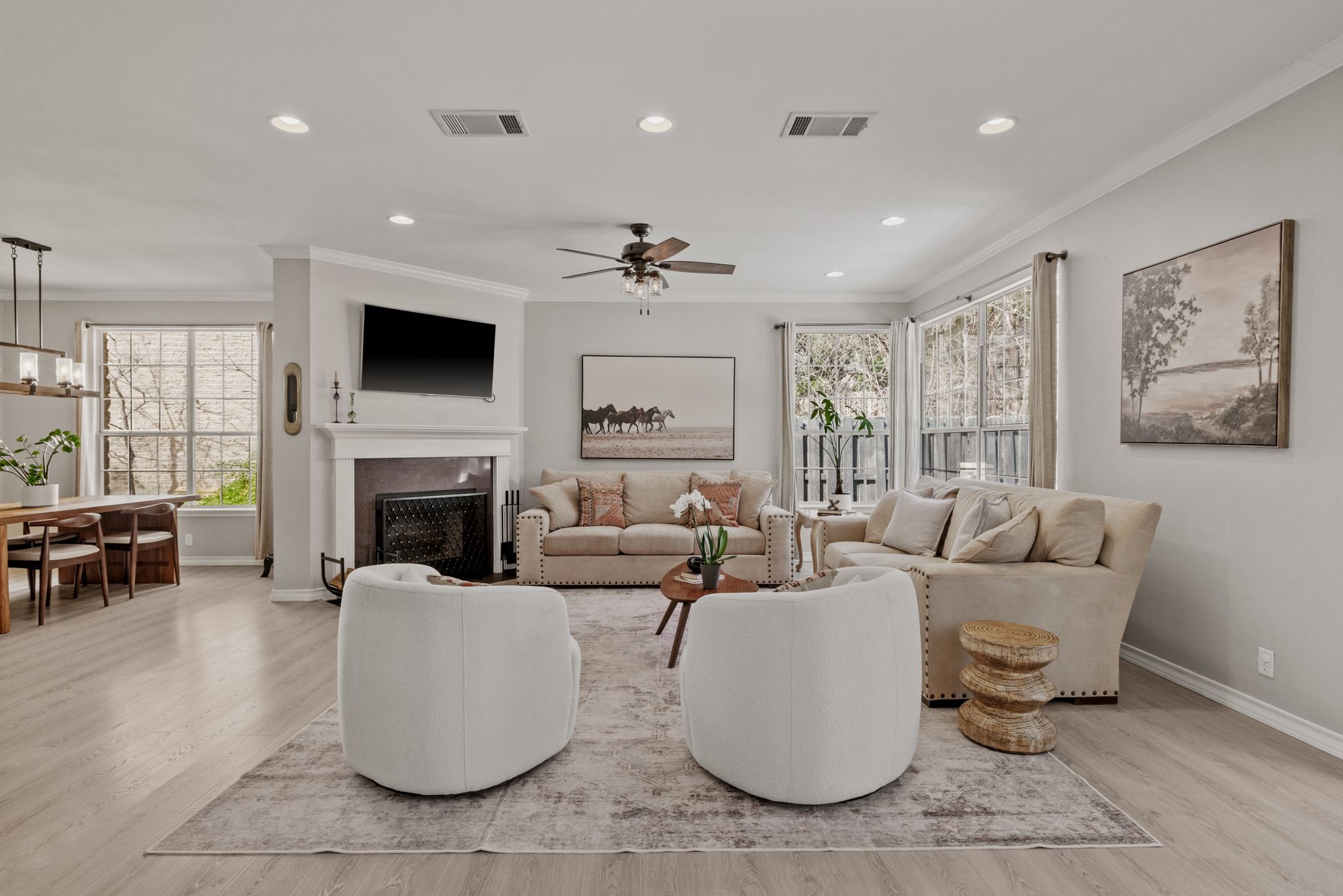 208 Sailors Run Lakeway, TX 78734 - Photo 5 of 40 The living room is enhanced with upscale crown molding, LED recessed lighting, and a traditional wood-burning fireplace that provides comfort and warmth during the wintertime.