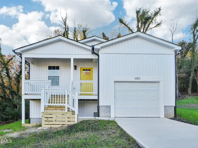 a view of house with yard