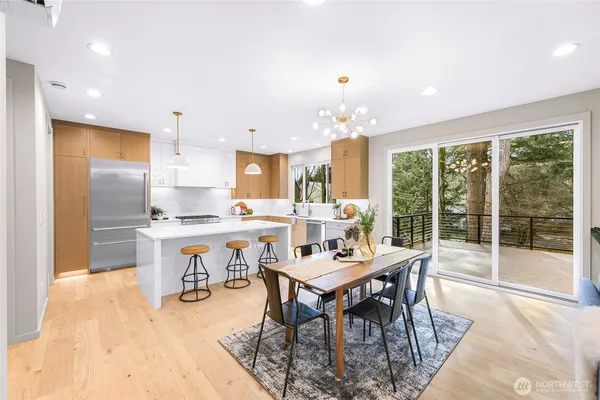 a kitchen with a table chairs stove and kitchen view