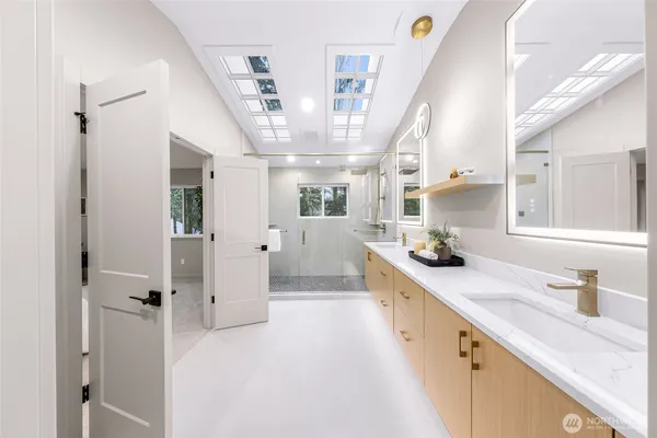 a large kitchen with a lot of counter space and wooden floor