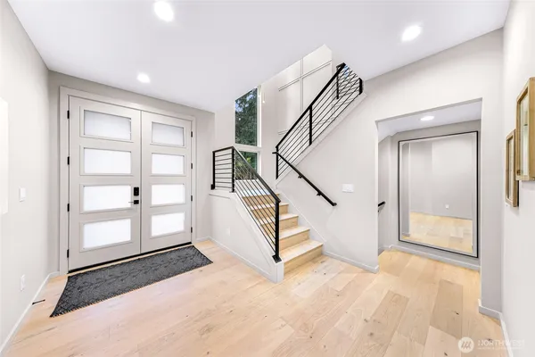 a view of entryway and hall with wooden floor