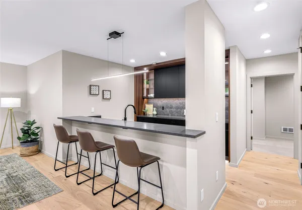a kitchen with sink a stove and cabinets