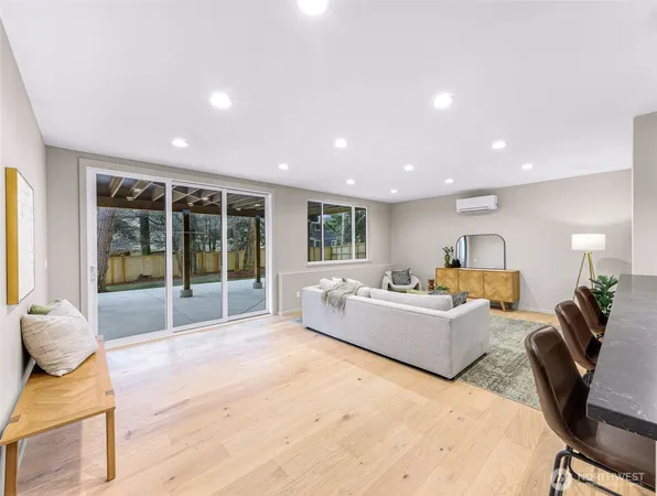 a living room with furniture kitchen view and a couch