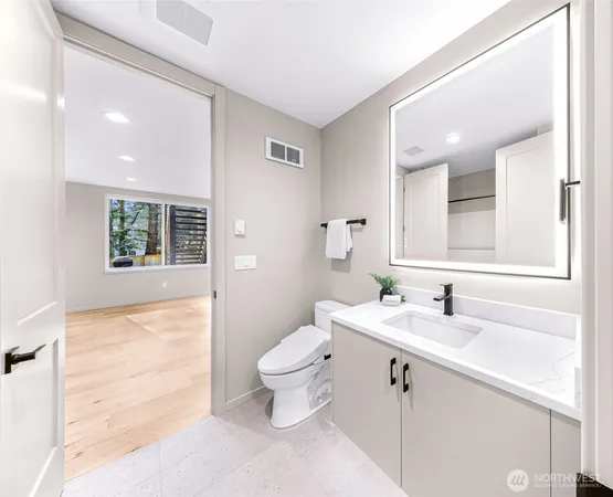 a bathroom with a tub sink and mirror