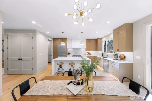a very nice looking dining room with a large dining table and a refrigerator