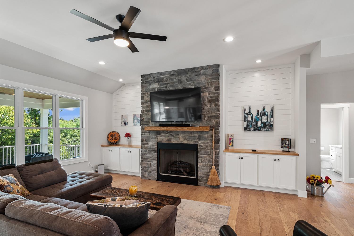 795 Madison Ridge Road Lawrenceburg, IN 47025 - Photo 5 of 68 Stacked stone fireplace flanked by buffet cabinets and shiplap siding accents
