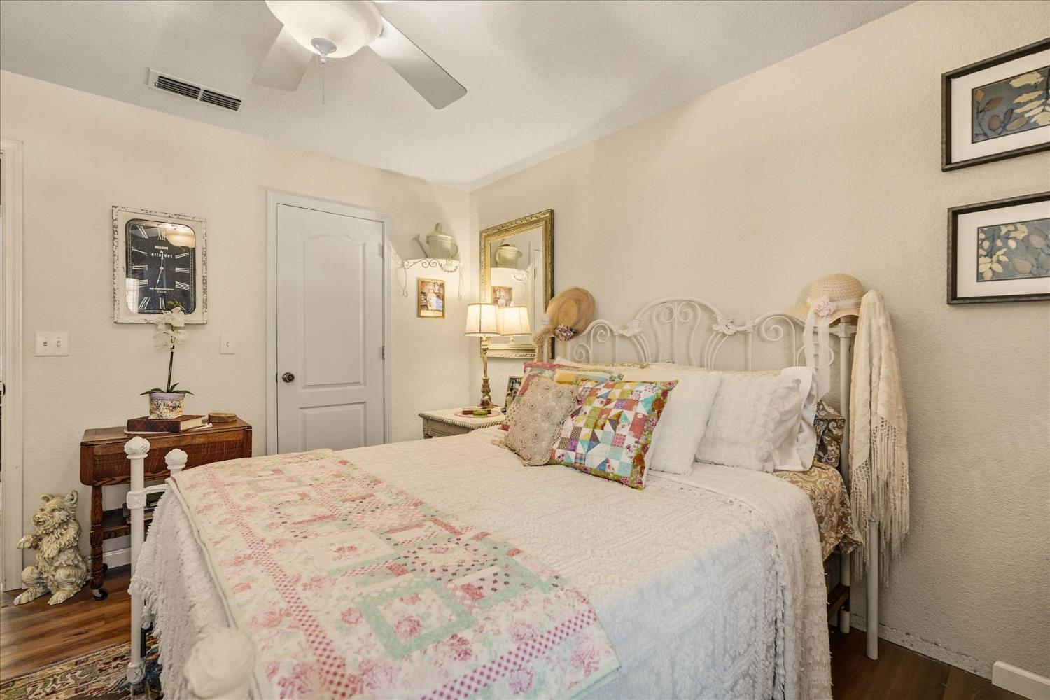 32583 River Knolls Road Coarsegold, CA 93614 - Photo 38 of 63 a bedroom with a bed and a chandelier