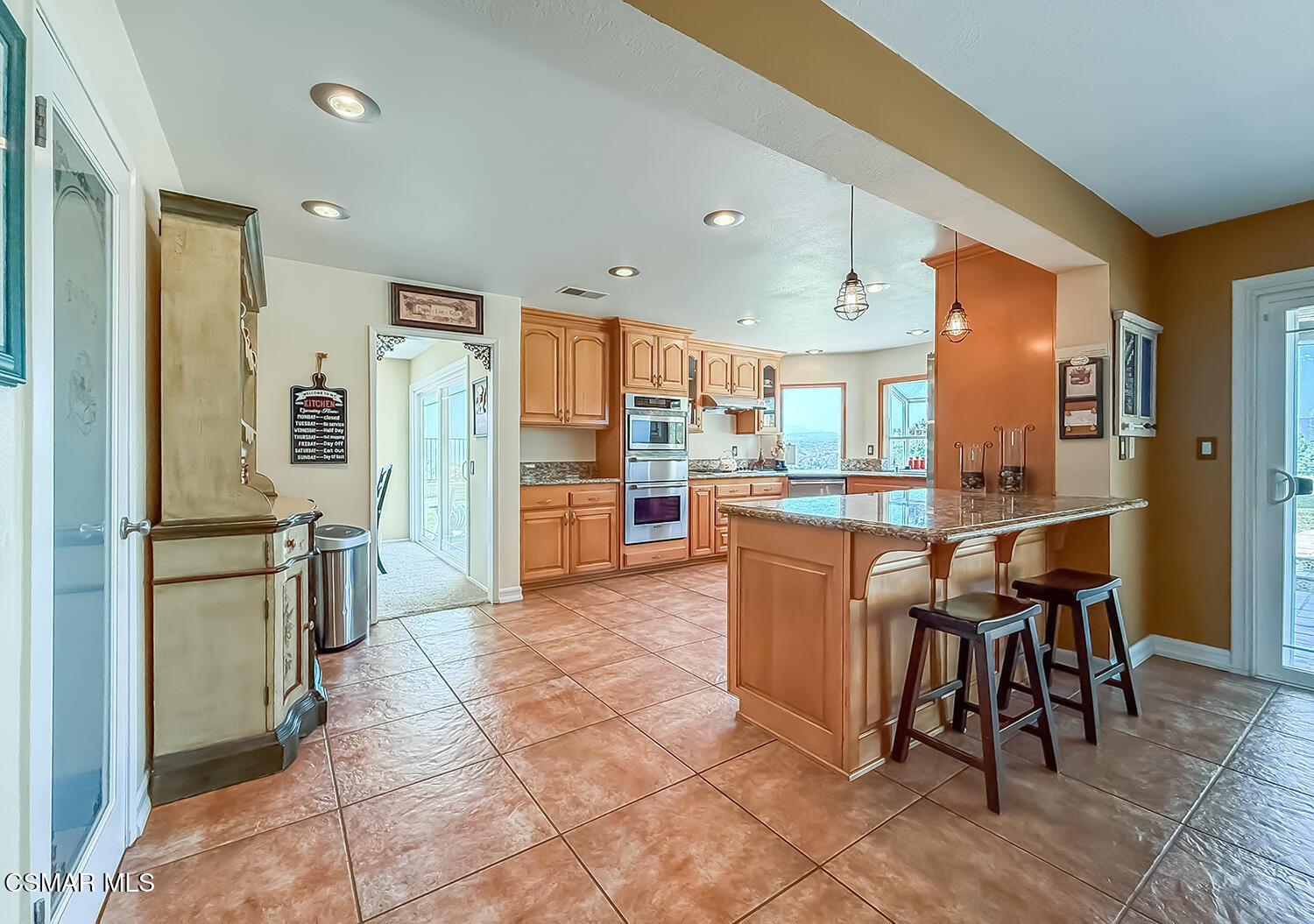 13749 Gunsmoke Road Moorpark, CA 93021 - Photo 22 of 61 a kitchen with stainless steel appliances granite countertop a refrigerator and a stove top oven