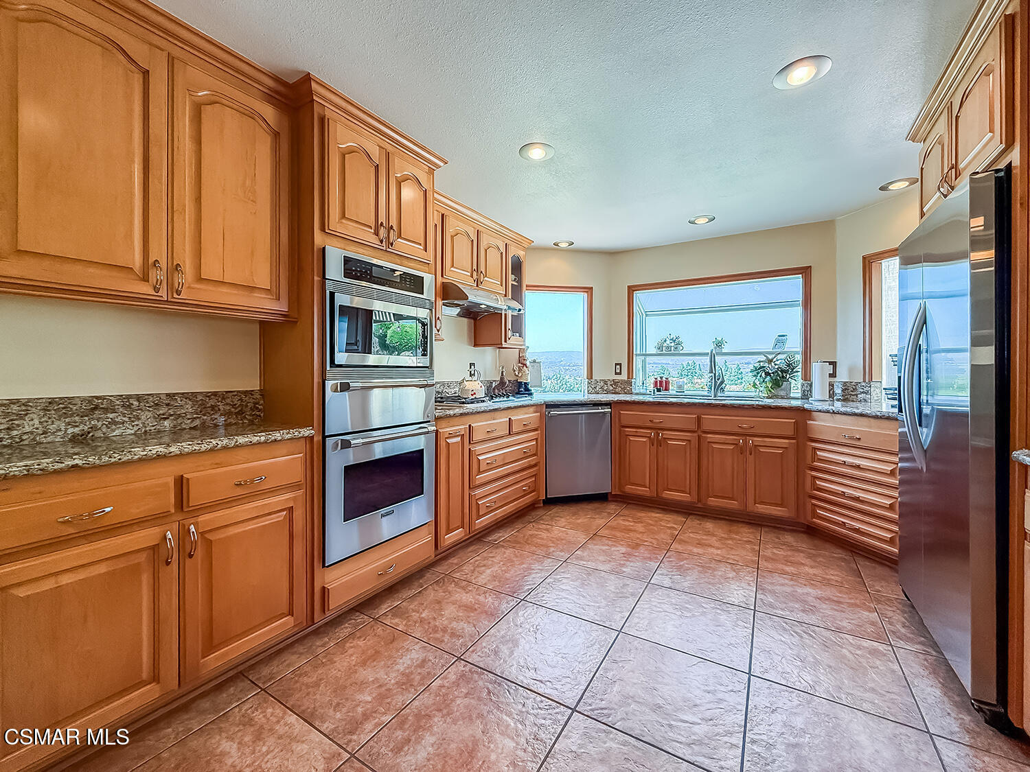 13749 Gunsmoke Road Moorpark, CA 93021 - Photo 23 of 61 a kitchen with stainless steel appliances granite countertop a stove and a sink