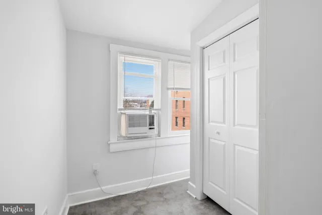 a view of wooden floor and cabinets in a room