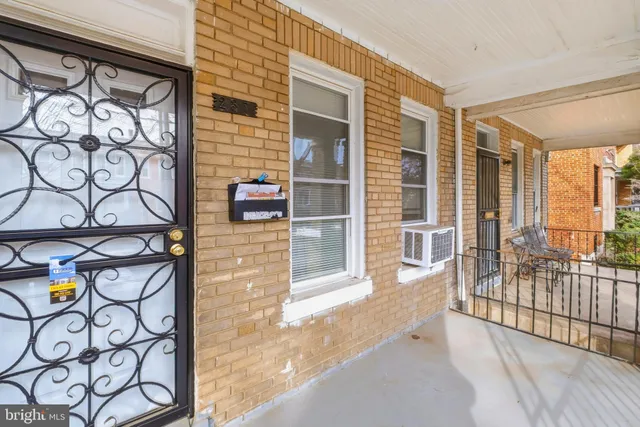 a view of a porch with a floor to ceiling window with wooden floor