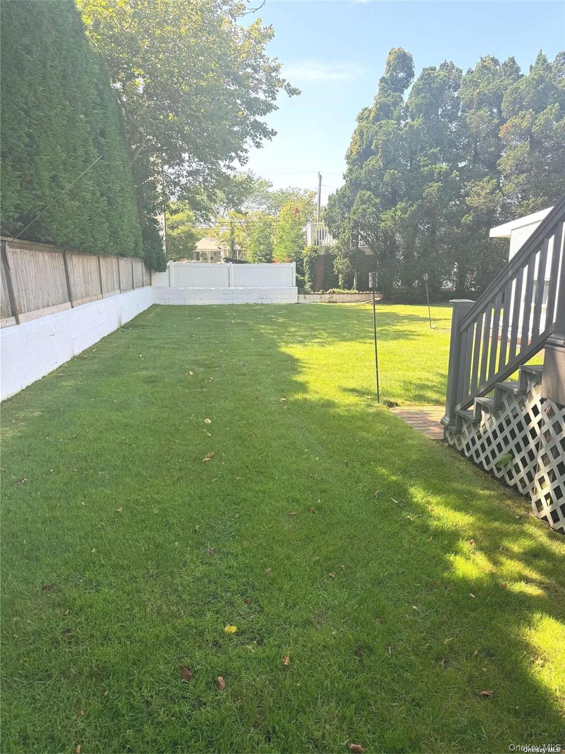 89 Lynbrook Avenue Point Lookout, NY 11569 - Photo 18 of 19 a view of a swimming pool with a yard