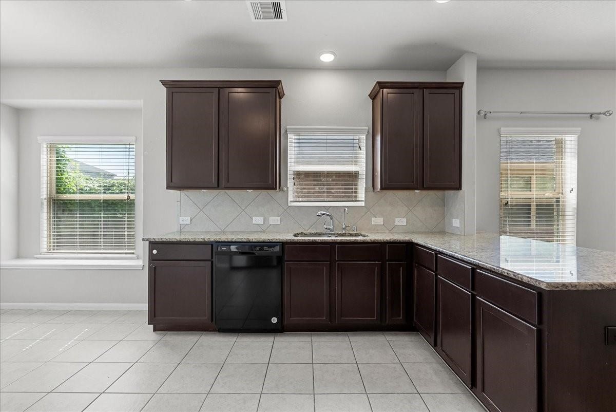 5111 Bay Lane Bacliff, TX 77518 - Photo 14 of 48 a kitchen with granite countertop a sink and a stove