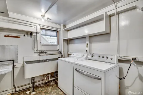 a utility room with cabinets dryer and washer