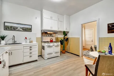 a view of kitchen with cabinets and wooden floor