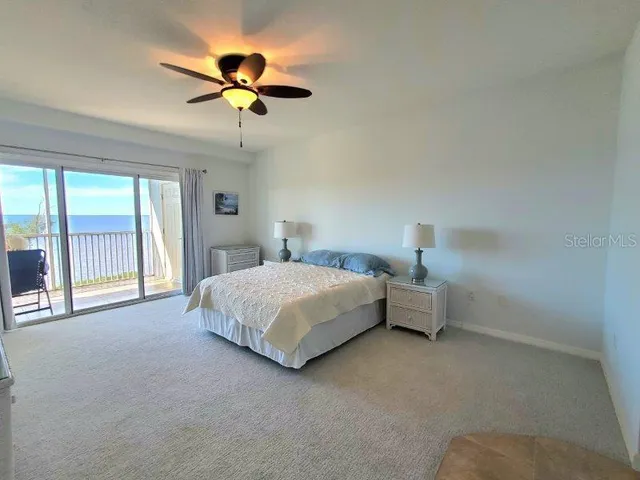 a spacious bathroom with a granite countertop sink a mirror and a bathtub