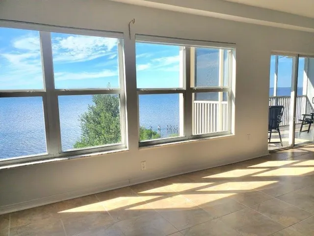 a view of a livingroom with furniture staircase and windows