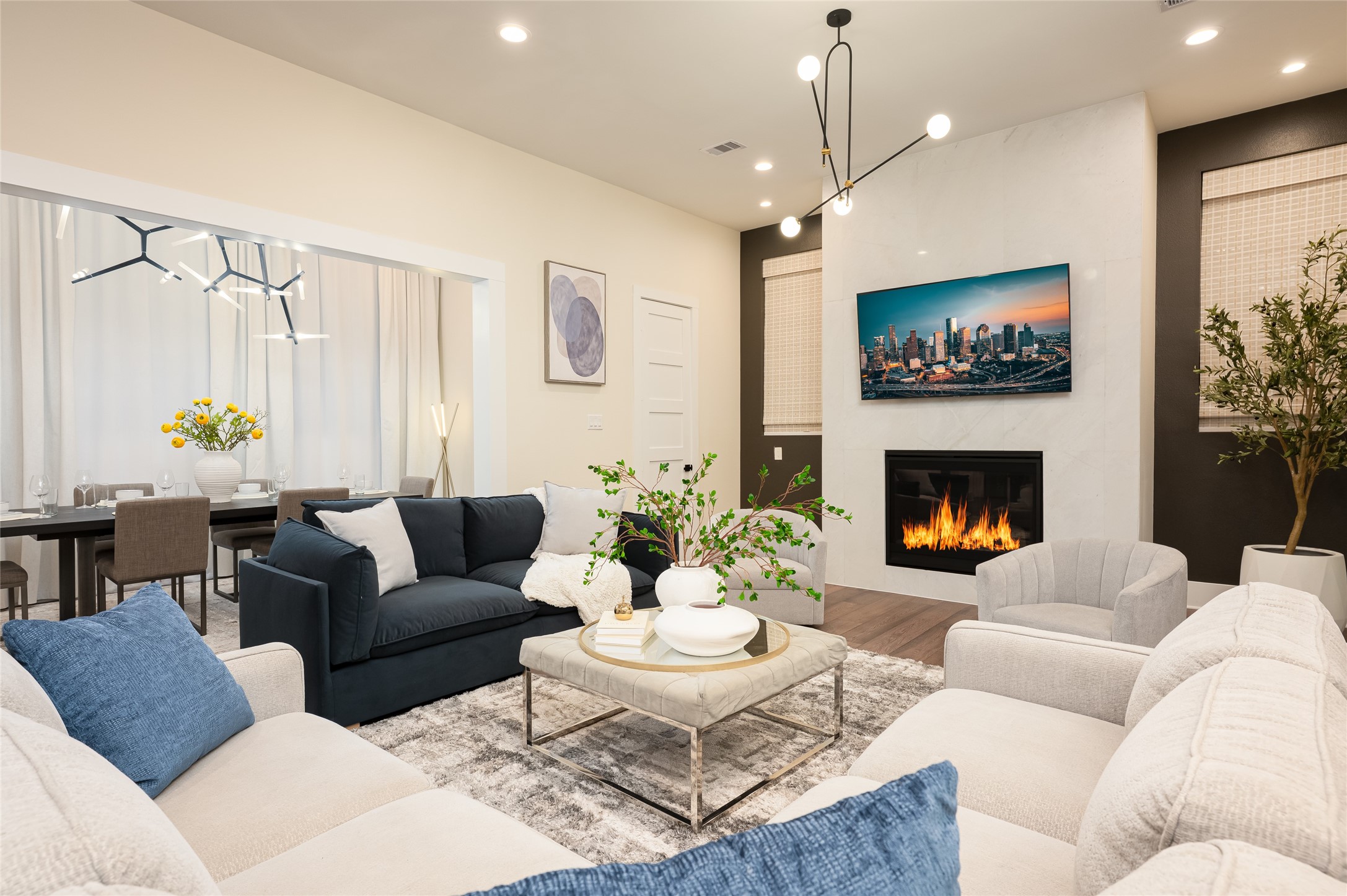 a living room with furniture a chandelier and a fireplace