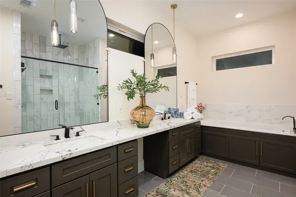 a bathroom with a double vanity sink and a mirror