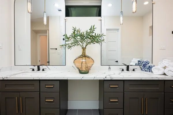 a bathroom with a double vanity sink and a mirror