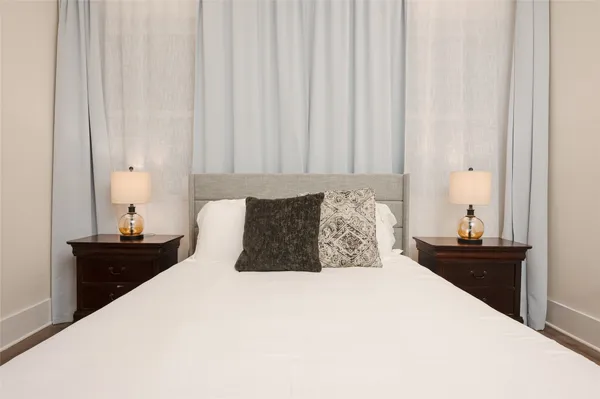 a bedroom with a bed and a night stand