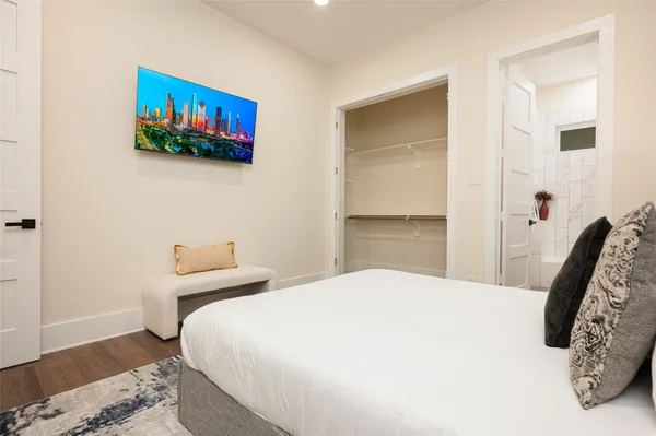 a bedroom with a bed and a flat screen tv