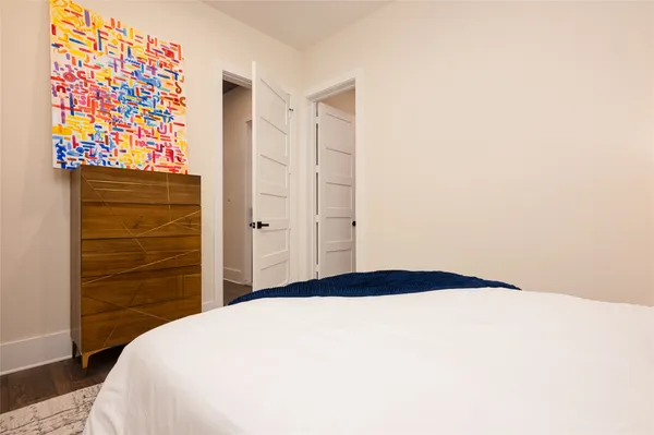 a bedroom with a bed and a dresser