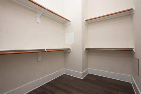 a view of a room with wooden floor