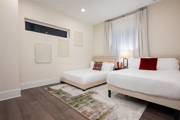 a bedroom with two beds and painting on the wall