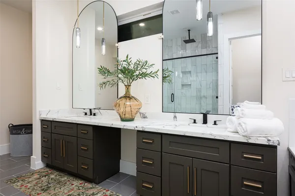 a bathroom with a double vanity sink and a mirror