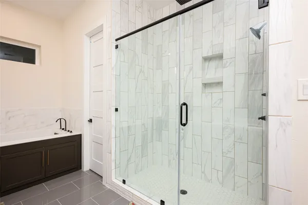 a bathroom with a bathtub and a shower