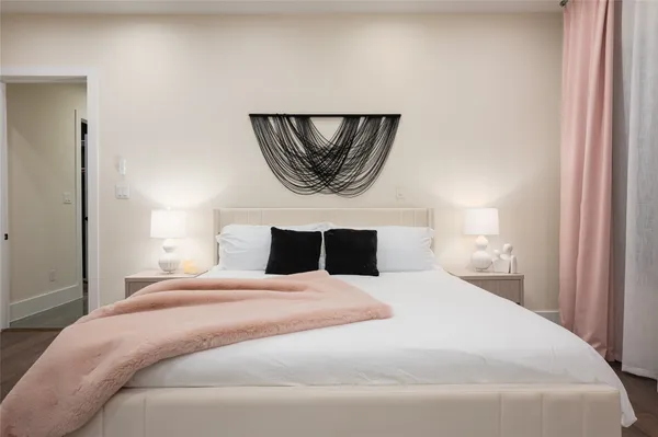 a bedroom with a bed and a painting on the wall